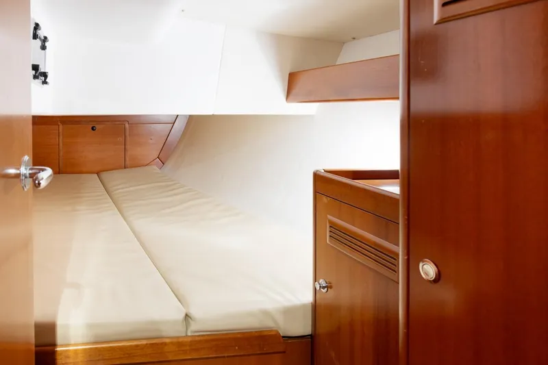 Slide: The Image of Cozy cabin interior of 2008 J Boats J/122, featuring wooden finishes and a comfortable berth. - 30