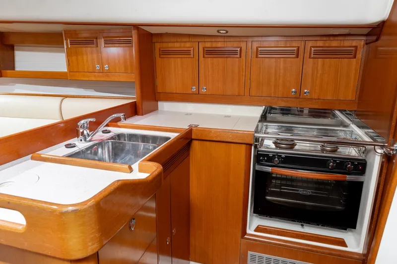 Slide: The Image of Interior of 2008 J Boats J/122 with wooden cabinets and wall-mounted light. - 32