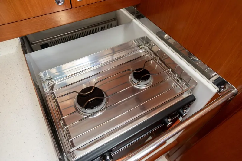 Slide: The Image of 2008 J Boats J/122 yacht kitchen with wooden cabinets, sink, and stove. - 33