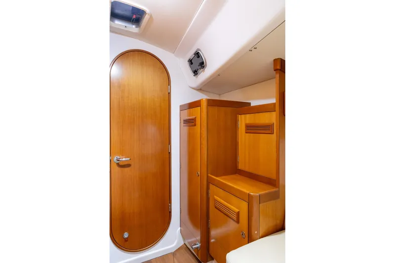 Slide: The Image of Interior of 2008 J Boats J/122 sailboat, featuring wooden cabinetry and seating. - 35