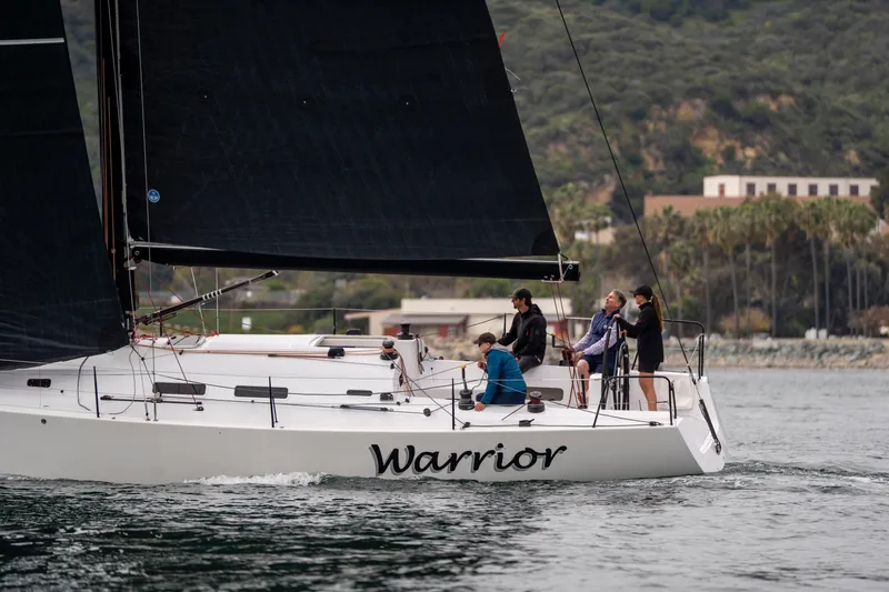 Slide: The Image of Person adjusting sails on a 2008 J Boats J/122 yacht. - 48