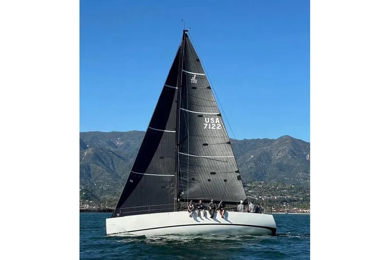 Slide: The Image of Sailboat J/122 from 2008 with spinnaker, birds flying overhead, ocean background. - 53