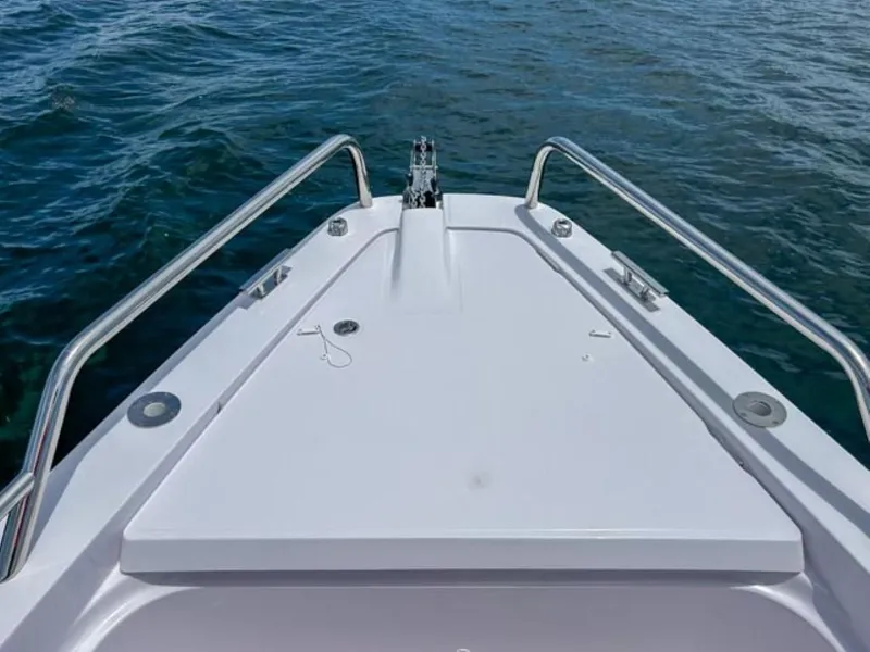 Slide: The Image of Bow of 2024 Axopar 37XC CROSS CABIN on water, featuring sleek design and stainless steel rails. - 19