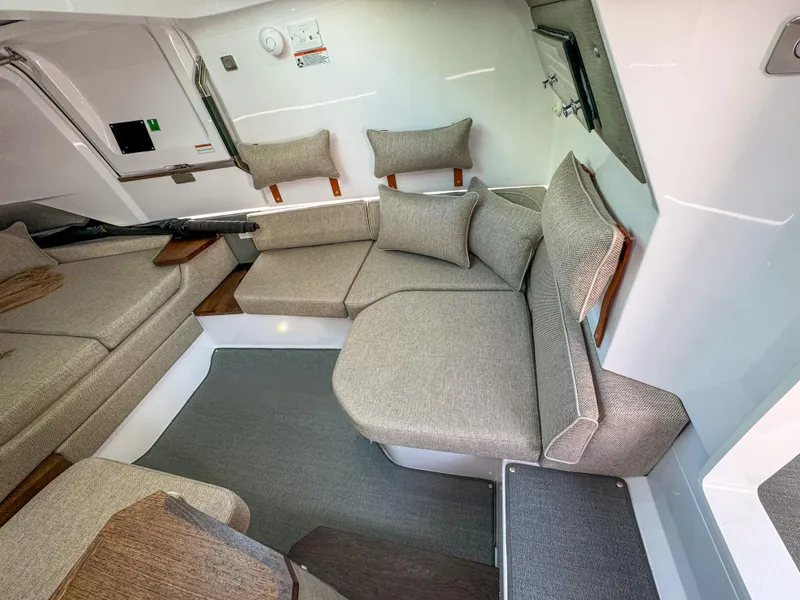 Slide: The Image of 2024 Axopar 37XC CROSS CABIN interior with modern seating and cushions. - 12