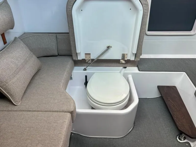 Slide: The Image of 2024 Axopar 37XC CROSS CABIN interior with hidden toilet under seat. - 15