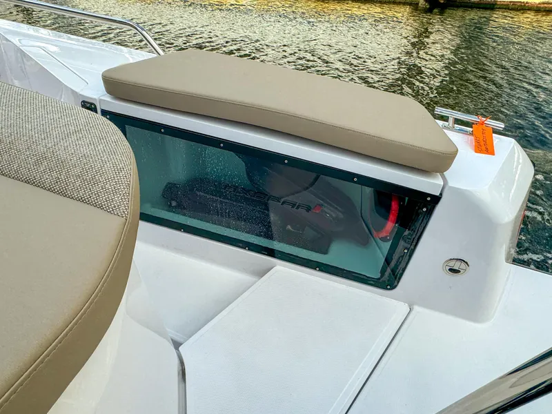 Slide: The Image of 2024 Axopar 37XC CROSS CABIN boat interior with cushioned seating and water view. - 8