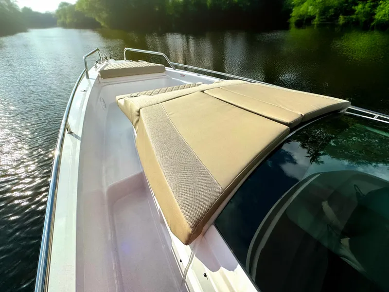 Slide: The Image of 2024 Axopar 37XC CROSS CABIN boat with sun deck on a serene river. - 9