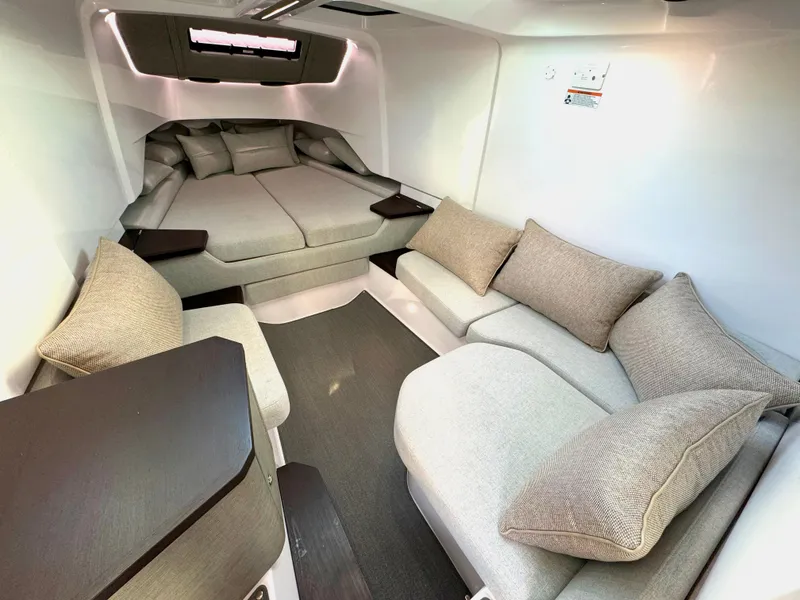 Slide: The Image of 2024 Axopar 37XC CROSS CABIN interior with cozy seating and modern design. - 18