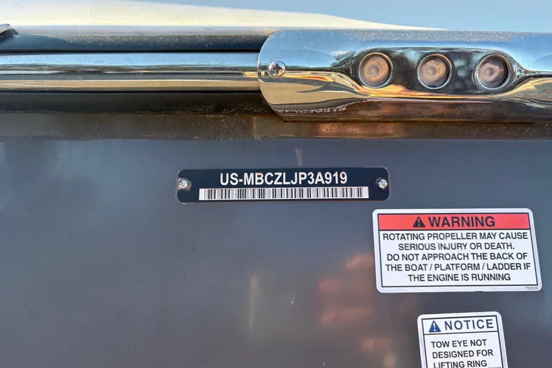 Slide: The Image of 2019 MasterCraft XStar boat with warning and notice labels on the hull. - 11