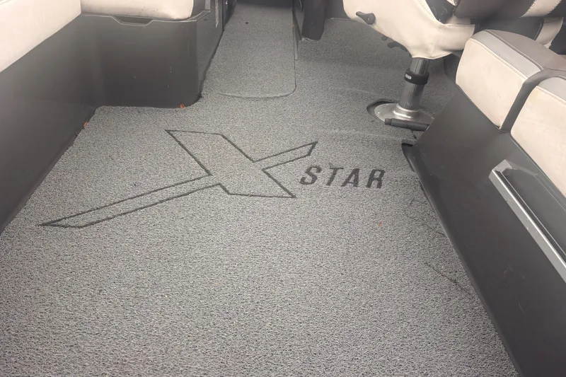 Slide: The Image of 2019 MasterCraft XStar interior with logo on carpeted floor. - 18