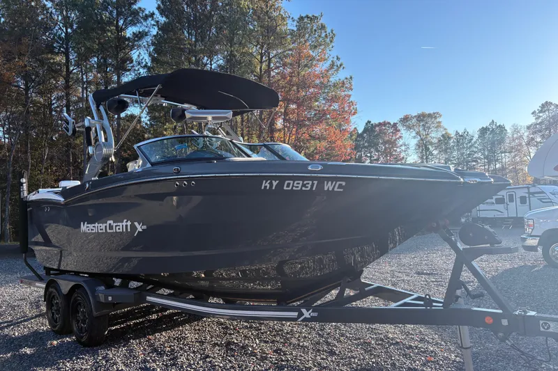 Slide: The Image of 2019 MasterCraft XStar boat on trailer in sunny outdoor setting. - 5