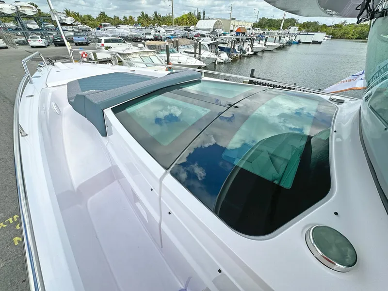 Slide: The Image of 2024 Axopar 37XC CROSS CABIN boat docked at marina, showcasing sleek design and spacious cabin. - 20