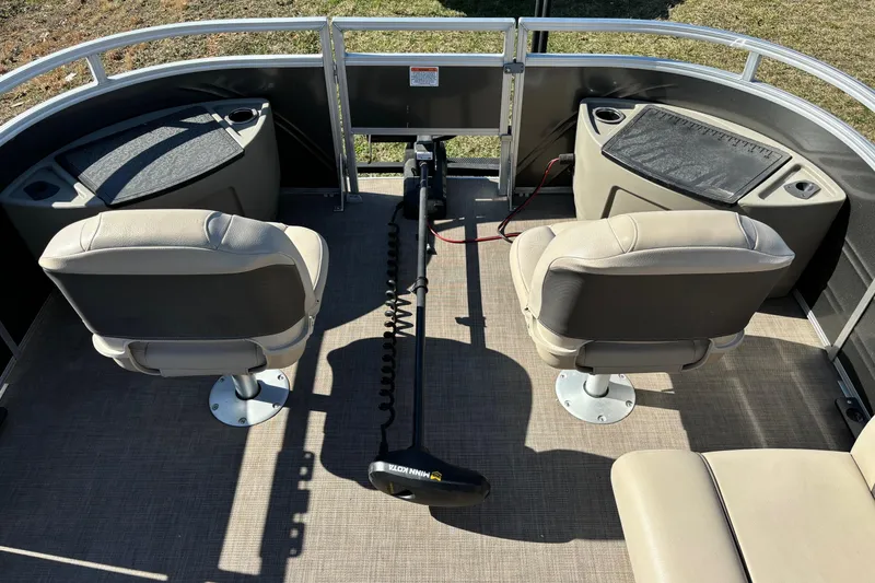 Slide: The Image of 2024 Sun Tracker Fishin' Barge 20 DLX interior with two swivel seats and fishing equipment. - 56