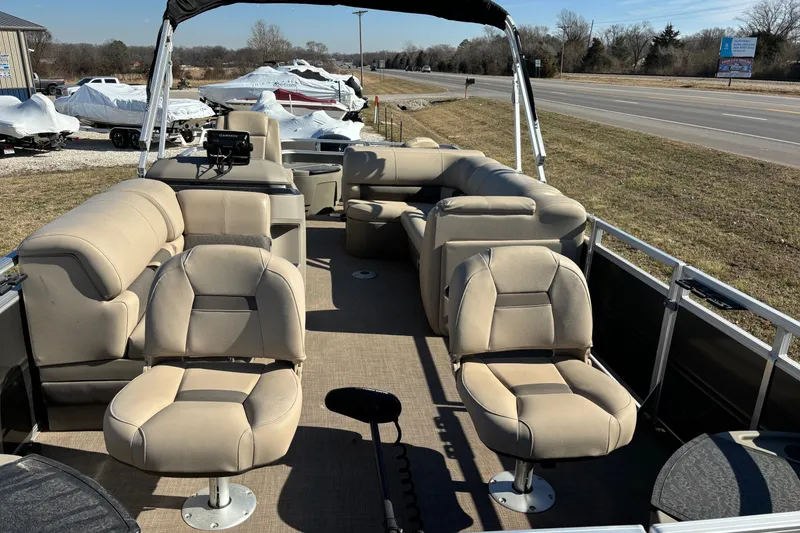 Slide: The Image of 2024 Sun Tracker Fishin' Barge 20 DLX pontoon boat with beige seating and open deck. - 57