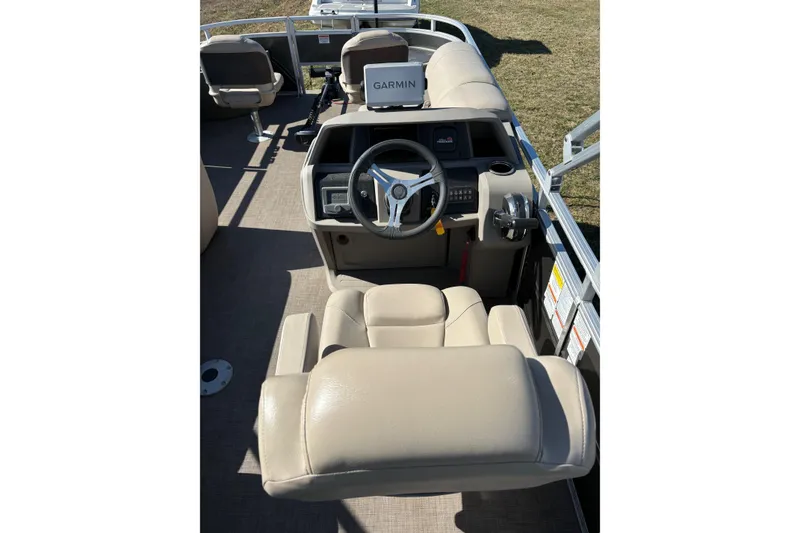 Slide: The Image of 2024 Sun Tracker Fishin' Barge 20 DLX interior with steering wheel and beige seating. - 60