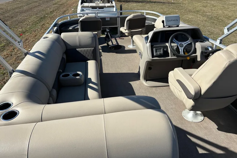 Slide: The Image of 2024 Sun Tracker Fishin' Barge 20 DLX interior with beige seating and Garmin navigation. - 61