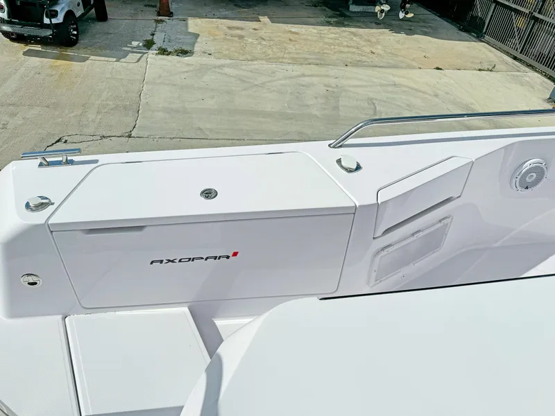Slide: The Image of 2024 Axopar 37XC CROSS CABIN boat deck with sleek white design and modern features. - 18