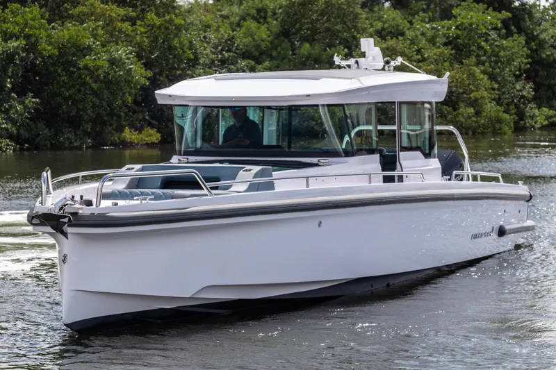 Slide: The Image of 2024 Axopar 37XC CROSS CABIN boat cruising on a calm waterway. - 25