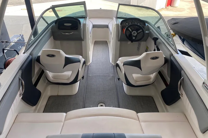 Slide: The Image of 2020 Chaparral 19 SSi boat interior with dual captain seats and steering console. - 4
