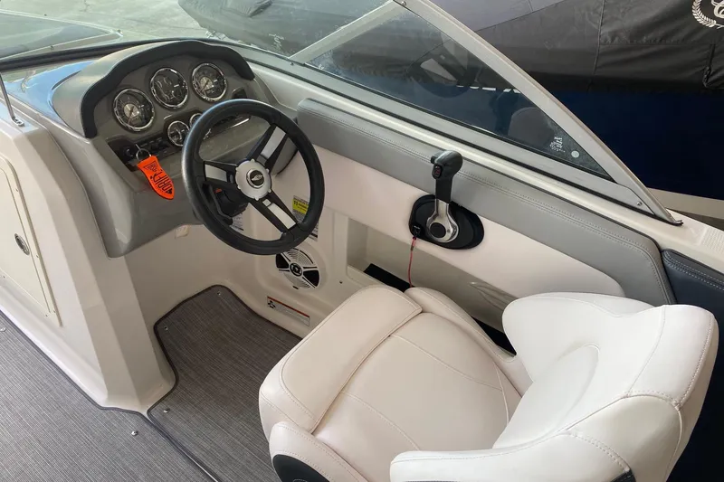 Slide: The Image of 2020 Chaparral 19 SSi boat interior with steering wheel and dashboard controls. - 5