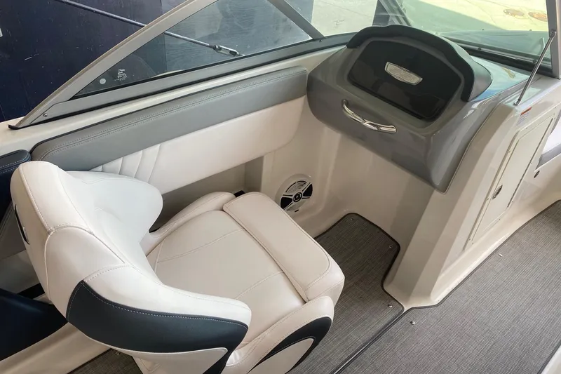 Slide: The Image of 2020 Chaparral 19 SSi boat interior with white seating and dashboard. - 7