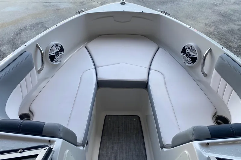 Slide: The Image of 2020 Chaparral 19 SSi boat interior with white seating and built-in speakers. - 8