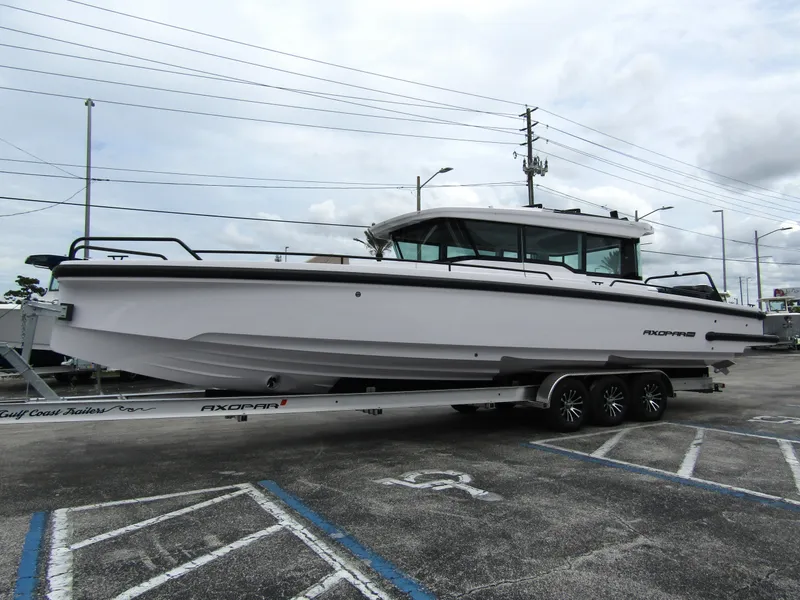 Slide: The Image of 2024 Axopar 37XC CROSS CABIN boat on trailer in parking lot. - 6