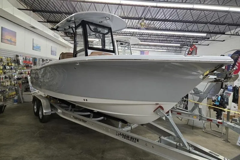 The Image of 2025 Sea Hunt Ultra 255 SE boat on trailer in showroom. - 0