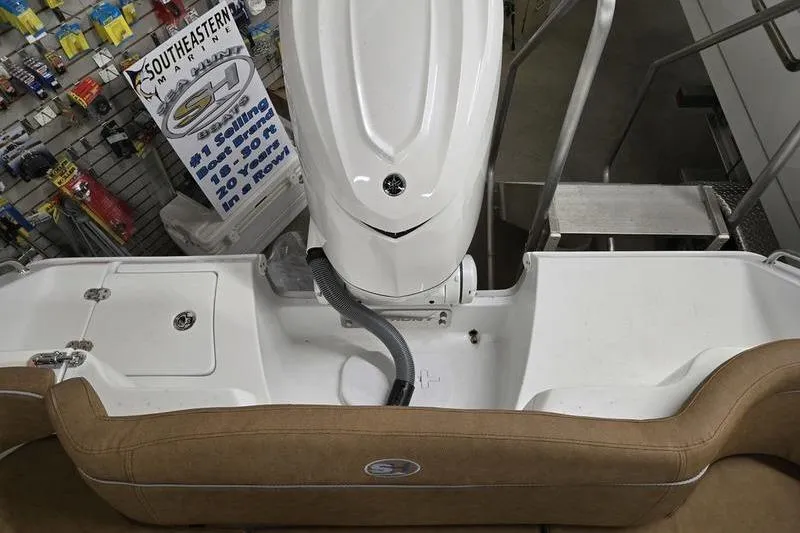 Slide: The Image of 2025 Sea Hunt Ultra 255 SE boat interior with engine and seating. - 13