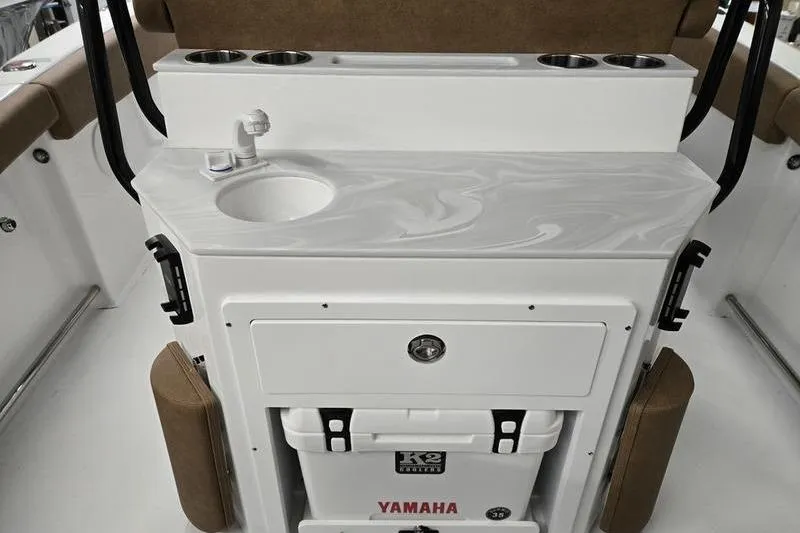 Slide: The Image of 2025 Sea Hunt Ultra 255 SE boat interior with sink and Yamaha cooler. - 14
