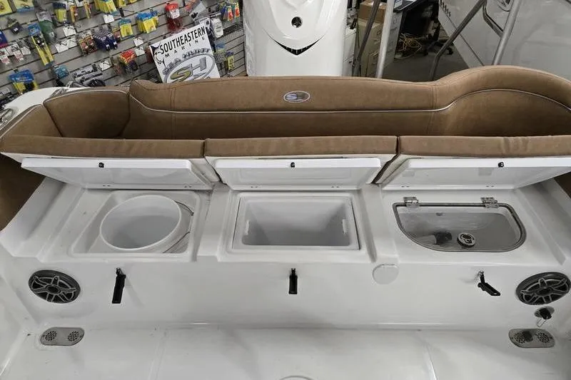 Slide: The Image of 2025 Sea Hunt Ultra 255 SE boat interior with storage compartments and seating. - 17