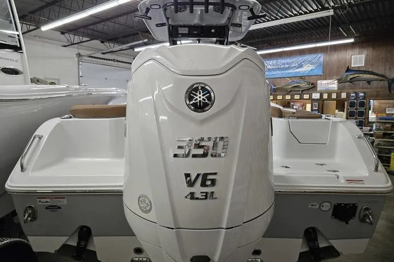 Slide: The Image of 2025 Sea Hunt Ultra 255 SE with Yamaha 350 V6 engine in showroom. - 2