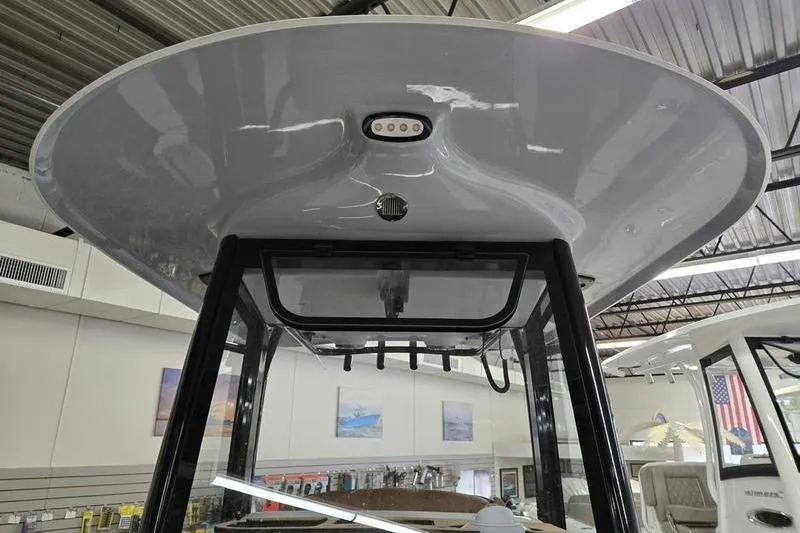 Slide: The Image of 2025 Sea Hunt Ultra 255 SE boat T-top with integrated lighting in showroom. - 4