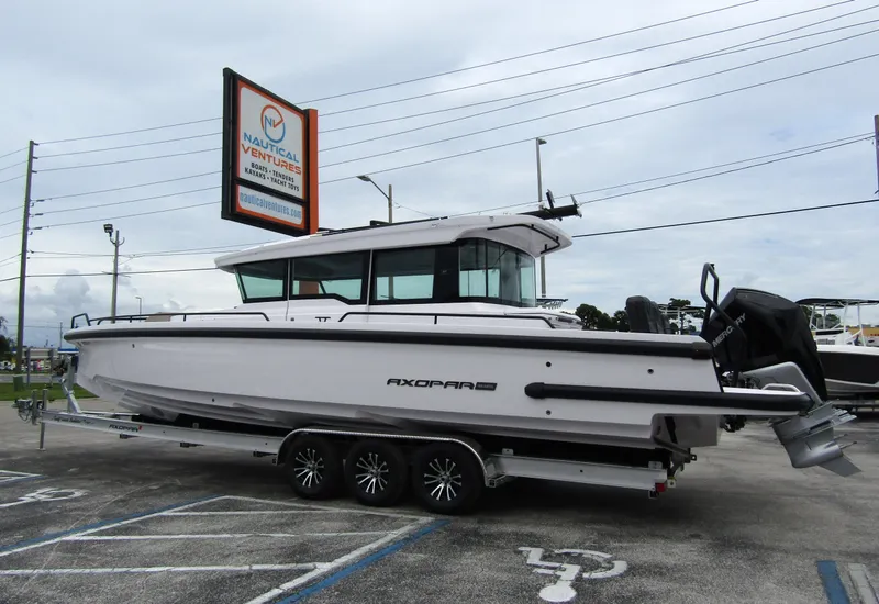 Slide: The Image of 2024 Axopar 37XC CROSS CABIN boat on trailer at dealership. - 1