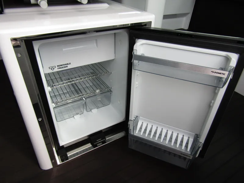 Slide: The Image of Open Dometic refrigerator in 2024 Axopar 37XC CROSS CABIN boat. - 24