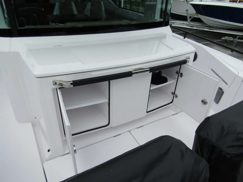 Slide: The Image of 2024 Axopar 37XC CROSS CABIN interior storage area with open compartments. - 31