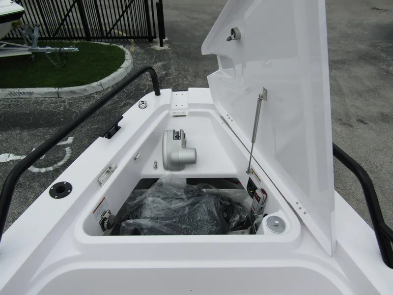 Slide: The Image of 2024 Axopar 37XC CROSS CABIN storage compartment with open hatch. - 8