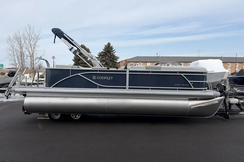 Slide: The Image of 2026 Godfrey Sweetwater 2086 C pontoon boat parked on asphalt lot. - 2