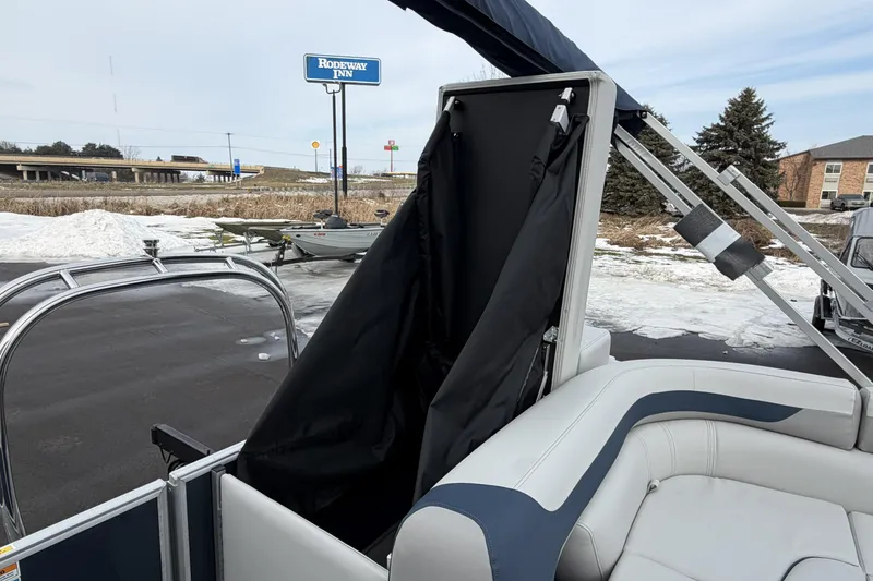 Slide: The Image of 2026 Godfrey Sweetwater 2086 C pontoon boat with seating and storage, parked near Rodeway Inn. - 20