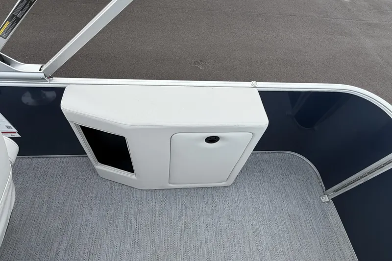 Slide: The Image of 2026 Godfrey Sweetwater 2086 C boat interior with storage compartment and carpeted floor. - 24