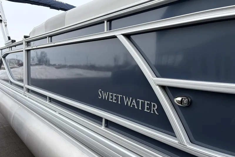 Slide: The Image of 2026 Godfrey Sweetwater 2086 C pontoon boat with sleek blue exterior design. - 25