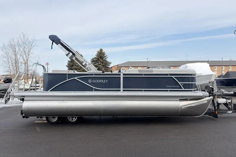Slide: The Image of 2026 Godfrey Sweetwater 2086 C pontoon boat on trailer, parked outdoors. - 3