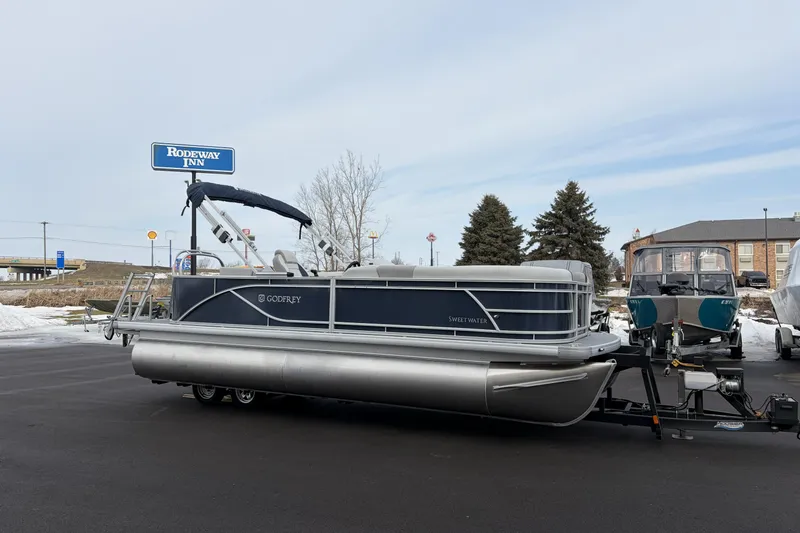 Slide: The Image of 2026 Godfrey Sweetwater 2086 C pontoon boat parked near Rodeway Inn. - 4