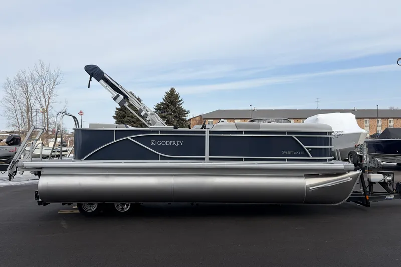 Slide: The Image of 2026 Godfrey Sweetwater 2086 C pontoon boat on trailer, parked outdoors. - 5