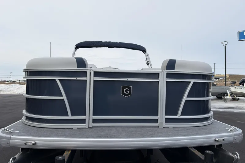 Slide: The Image of 2026 Godfrey Sweetwater 2086 C pontoon boat, rear view, in a parking lot. - 6