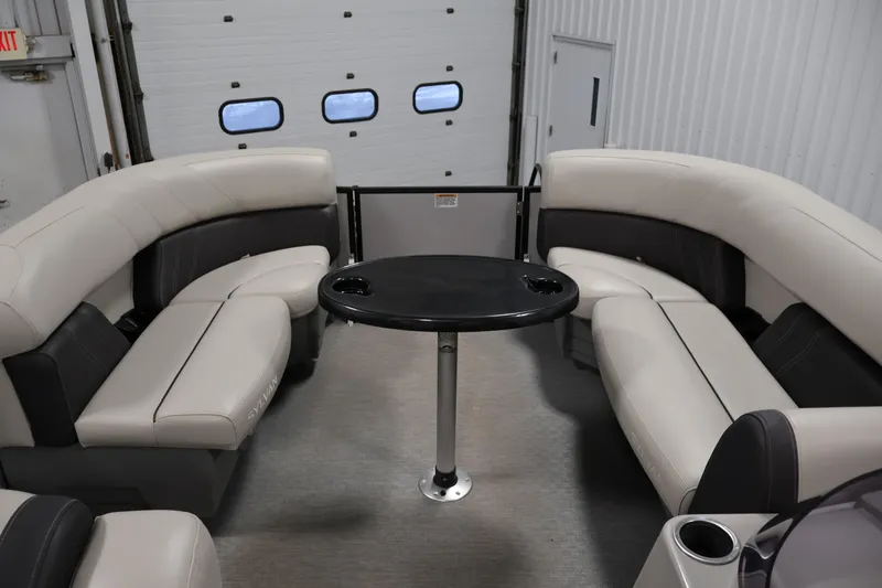 Slide: The Image of Interior of 2021 Sylvan 8522 Mirage pontoon boat with plush seating and table. - 11