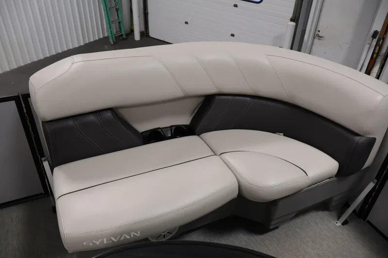 Slide: The Image of 2021 Sylvan 8522 Mirage boat interior with beige and black seating. - 12