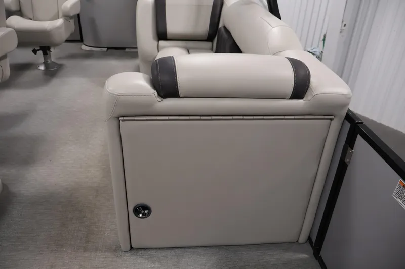 Slide: The Image of 2021 Sylvan 8522 Mirage interior seating with beige upholstery and storage compartment. - 18