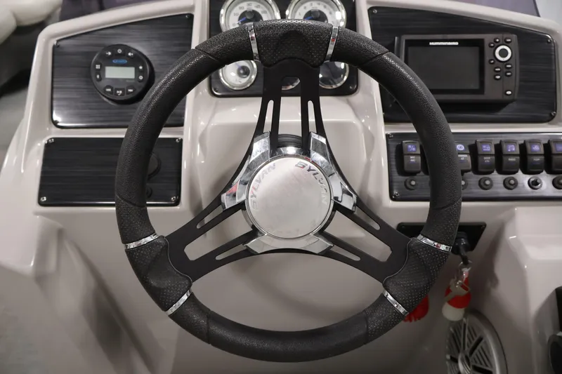 Slide: The Image of Steering wheel and dashboard of 2021 Sylvan 8522 Mirage boat. - 23
