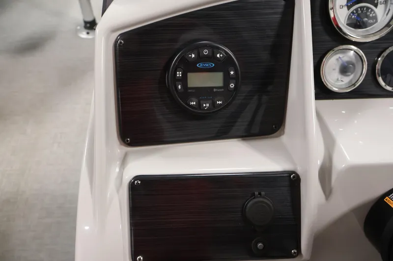 Slide: The Image of 2021 Sylvan 8522 Mirage dashboard with control panel and gauges. - 25